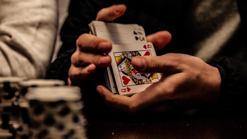 person holding king of spade playing card