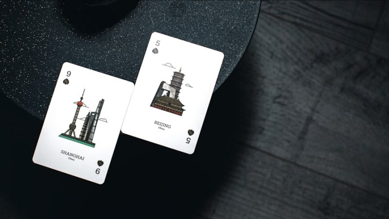 9 and 5 playing cards on black surface